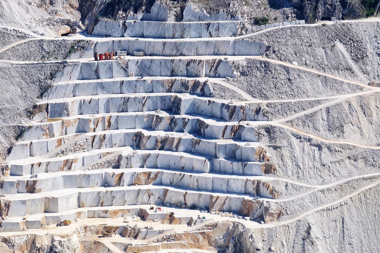 The quarry where Mara chooses her stone, block by block.